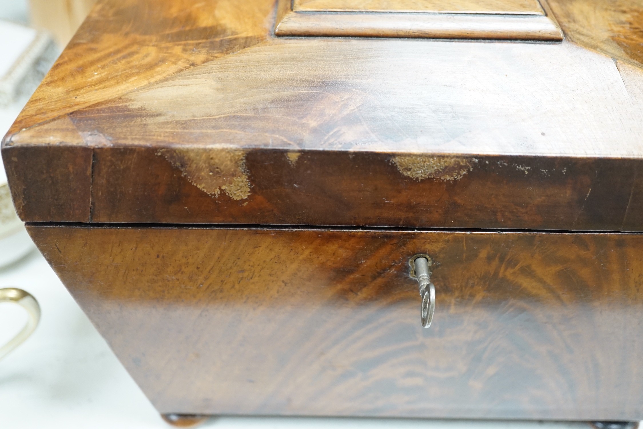 A Victorian boxwood strung burr yew sarcophagus shaped tea caddy, another mahogany tea caddy, a brass bound mahogany silver box with Bramah lock and another mahogany box. Largest 40cm wide